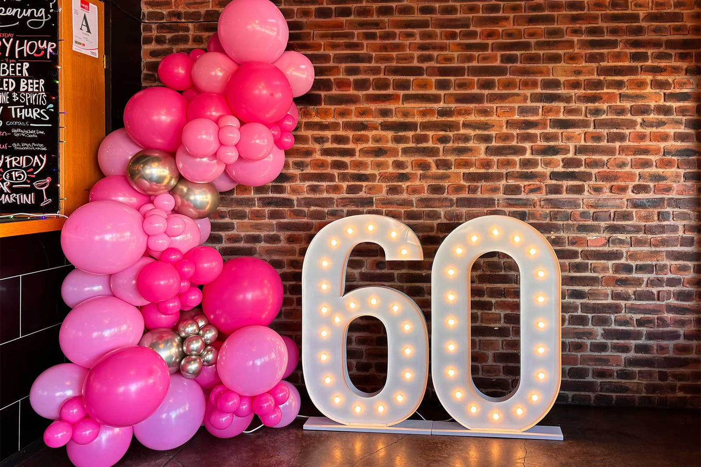 60 marquee lights surrounded by a colourful balloon garland for party decoration and photos