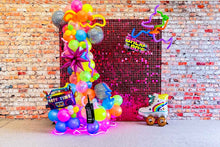 Load image into Gallery viewer, An 80's/Disco themed event backdrop featuring a hot pink shimmer wall, with balloons in vibrant colors, and decorative items such as a light-up sneaker and a record.