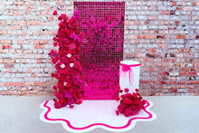 Load image into Gallery viewer, Decorative setup with pink flowers and a pink mesh screen against a brick wall.