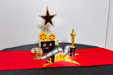 Load image into Gallery viewer, Decorative Centrepiece with Oscar statue, star, and film reel on a red table runner