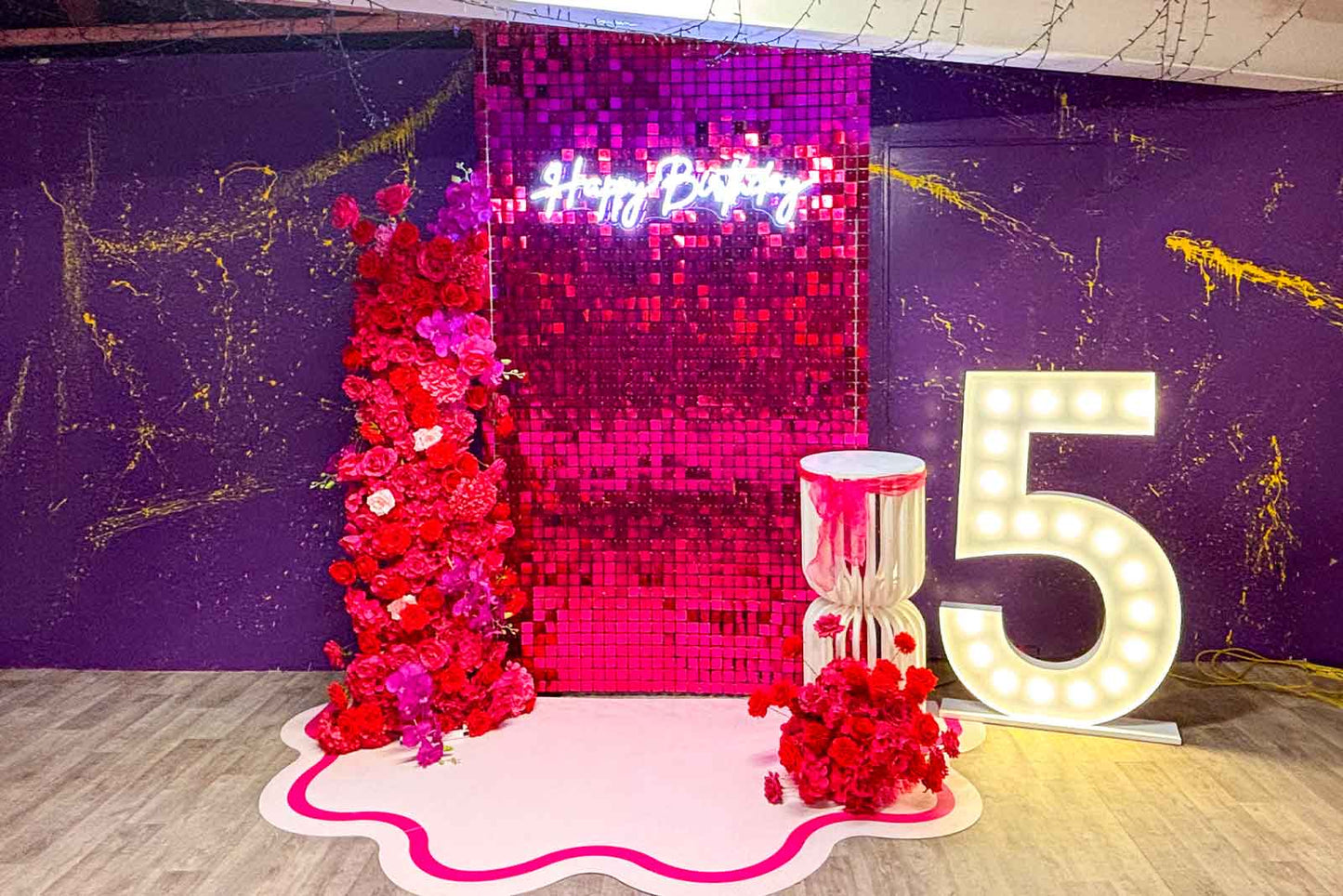Hot pink shimmer wall backdrop creating a fun and vibrant photo area for birthdays