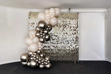 Load image into Gallery viewer, A balloon garland featuring balloons in white and white gold shades, arranged in front of a reflective, grid-patterned backdrop.