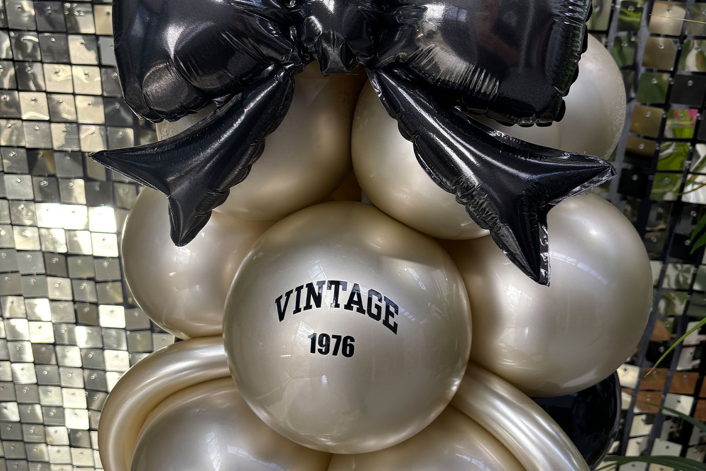 Champagne bottle themed balloon column creating a striking focal point for events and special celebrations.