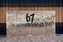 Load image into Gallery viewer, Custom event signage displayed on a white and gold shimmer wall at a corporate event in Auckland.