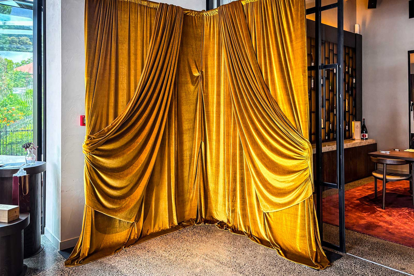 Gold velvet draping detailed in corner for elegant event styling