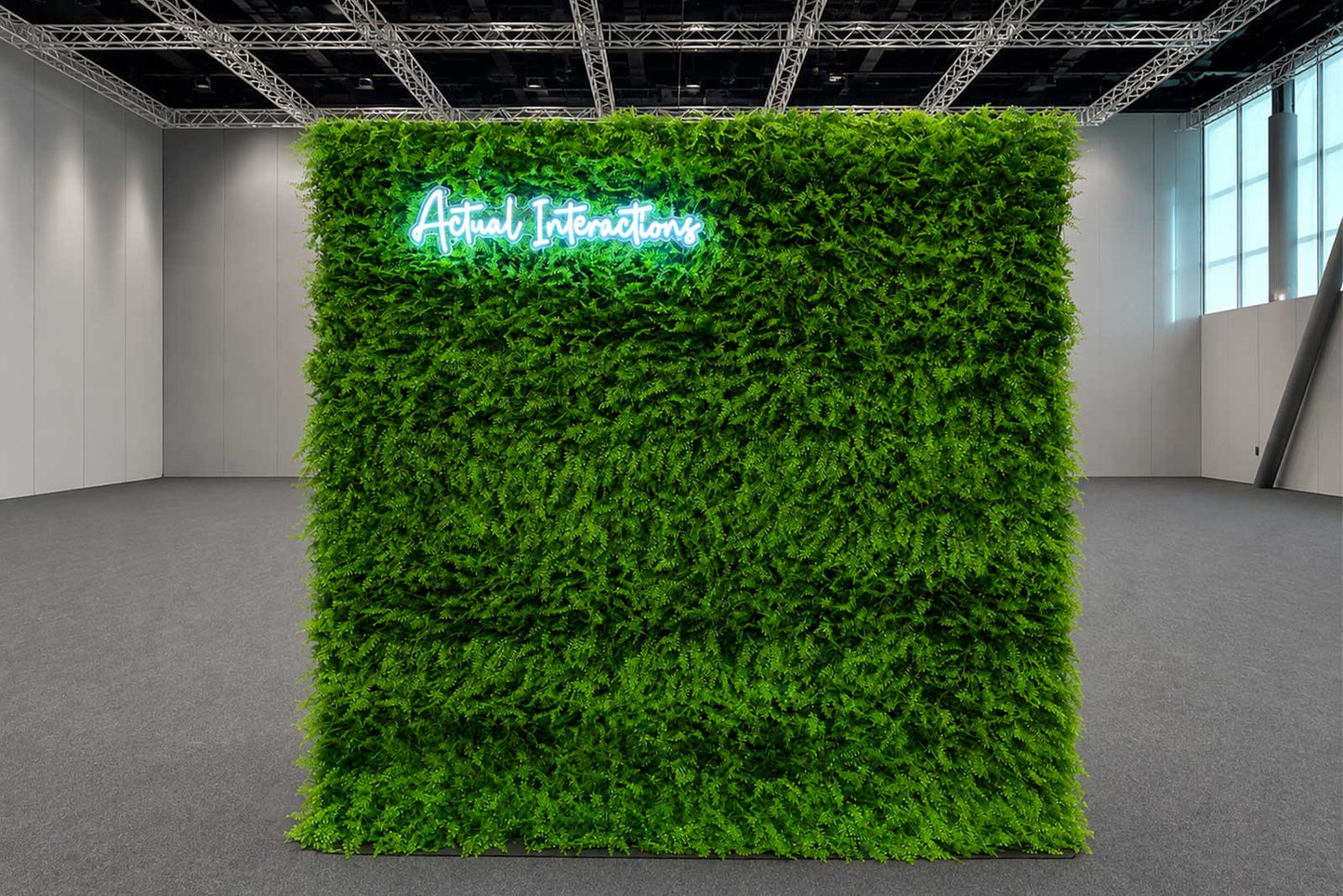 Green wall backdrop with a custom LED neon sign, ideal for weddings, corporate events, birthdays, and brand activations in Auckland.