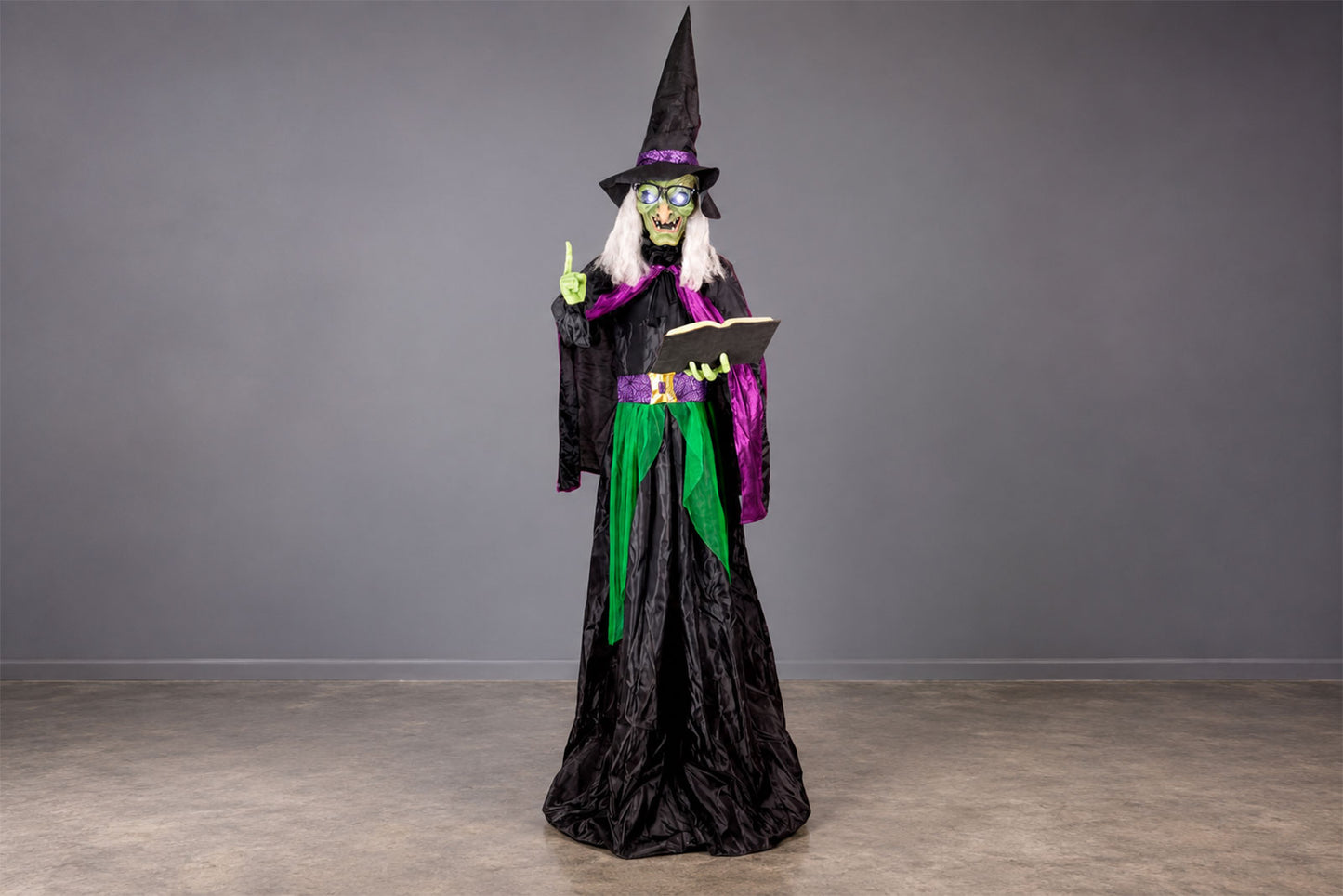 Halloween witch decoration prop with black robe, pointed hat and purple and green details