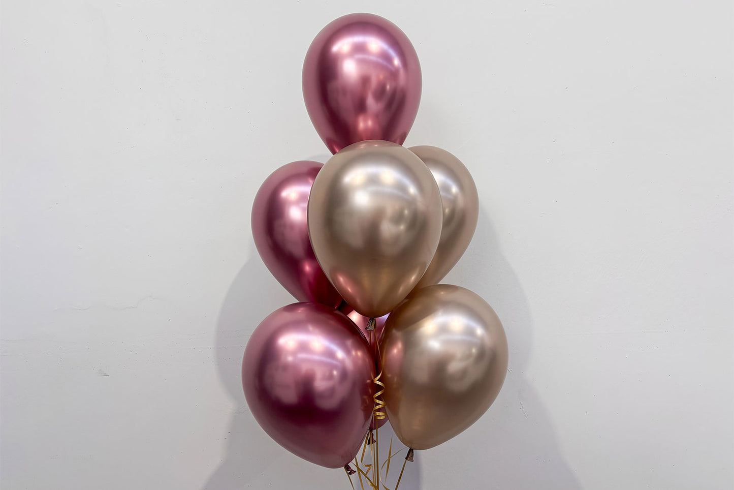 Seven helium balloons arranged in a stylish event display for birthday party or corporate celebration in Auckland.
