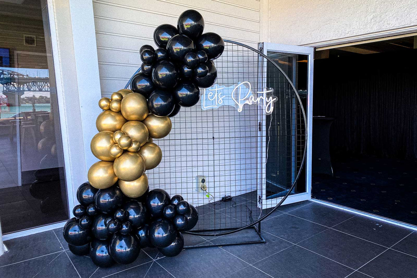 Mesh circle backdrop with Let's Party neon sign for birthday or celebration décor