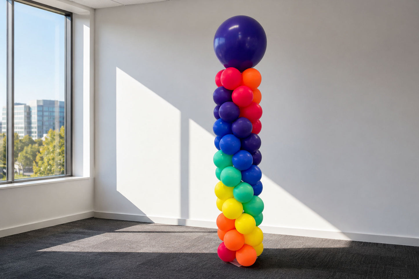 Spiral rainbow balloon arch for birthdays, pride events, school functions and corporate celebrations in Auckland.