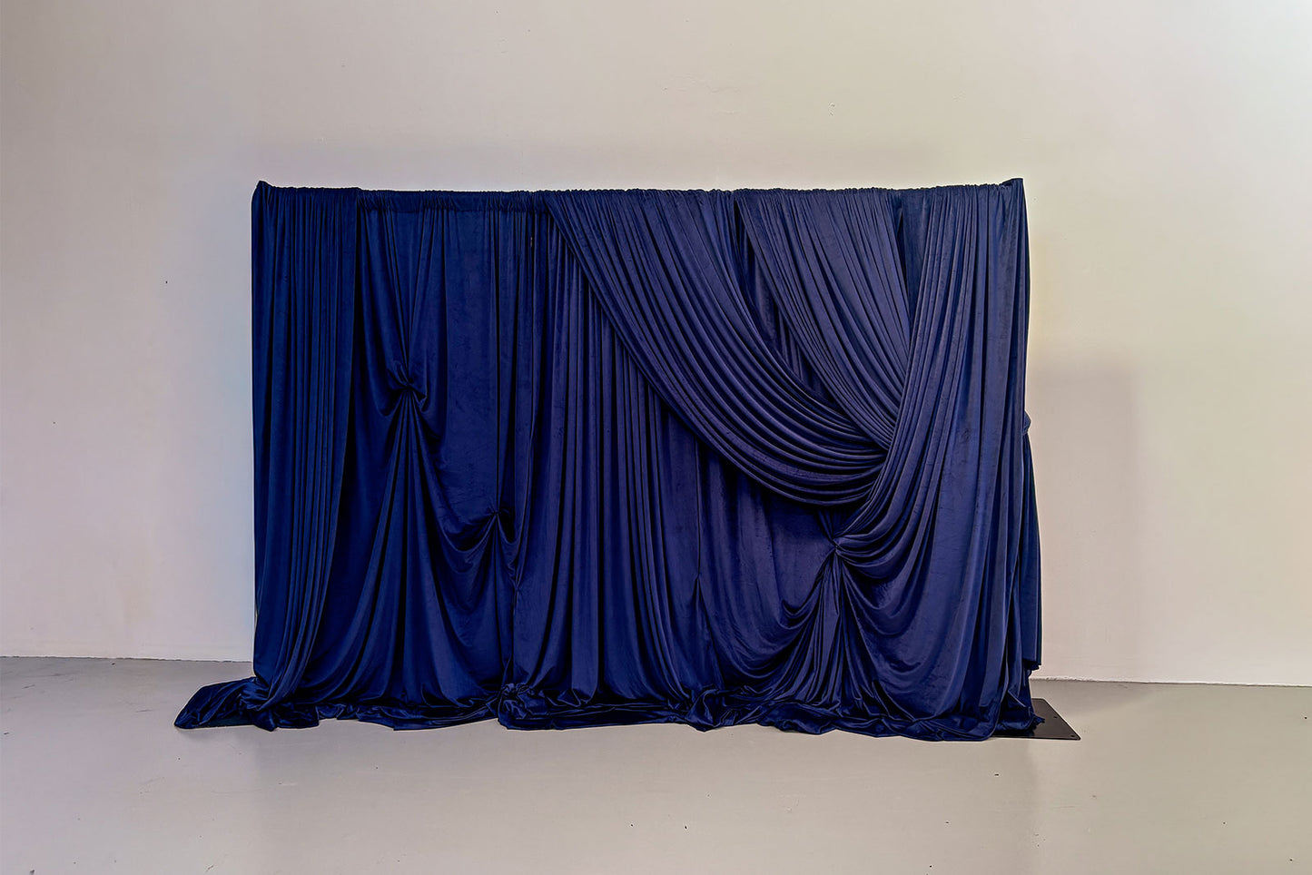Velvet navy backdrop draping setup for event styling and photo backdrop hire.