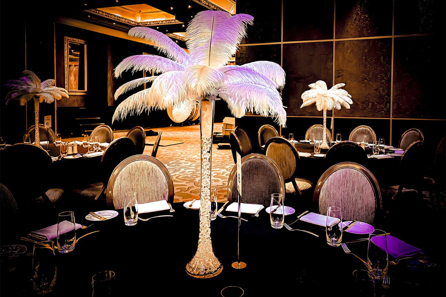 Luxury white feather centrepiece styled for a wedding reception table setting