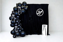 Load image into Gallery viewer, Black balloon arch with a black velvet backdrop 
