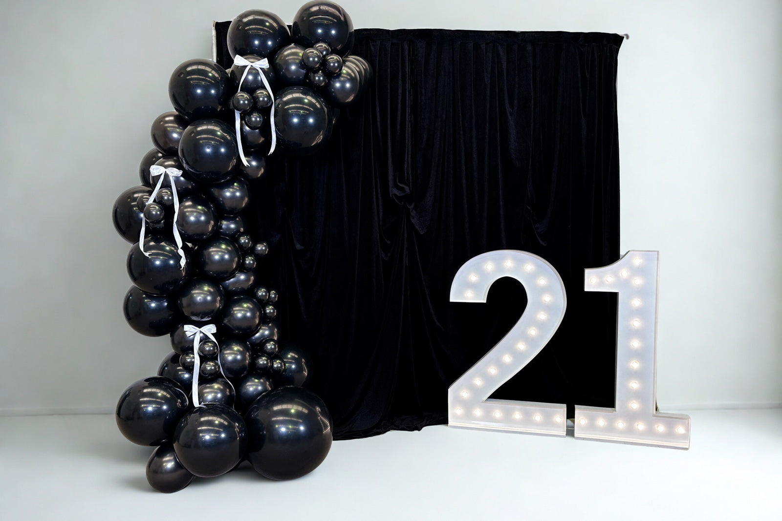 21st birthday decorations NZ with statement backdrop and balloon arch