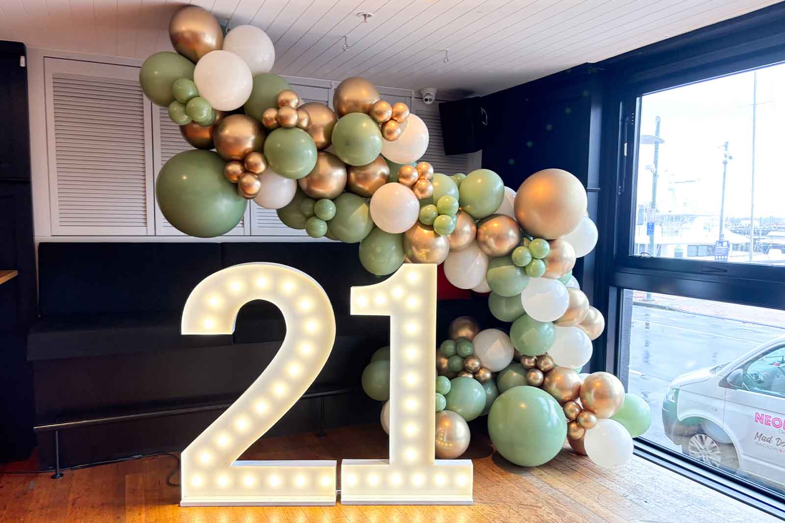 21st birthday decorations NZ with marquee numbers and balloon garland