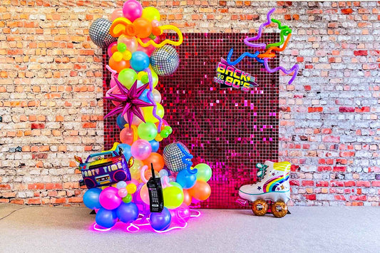 80s disco themed event backdrop with balloons and neon party styling in Auckland