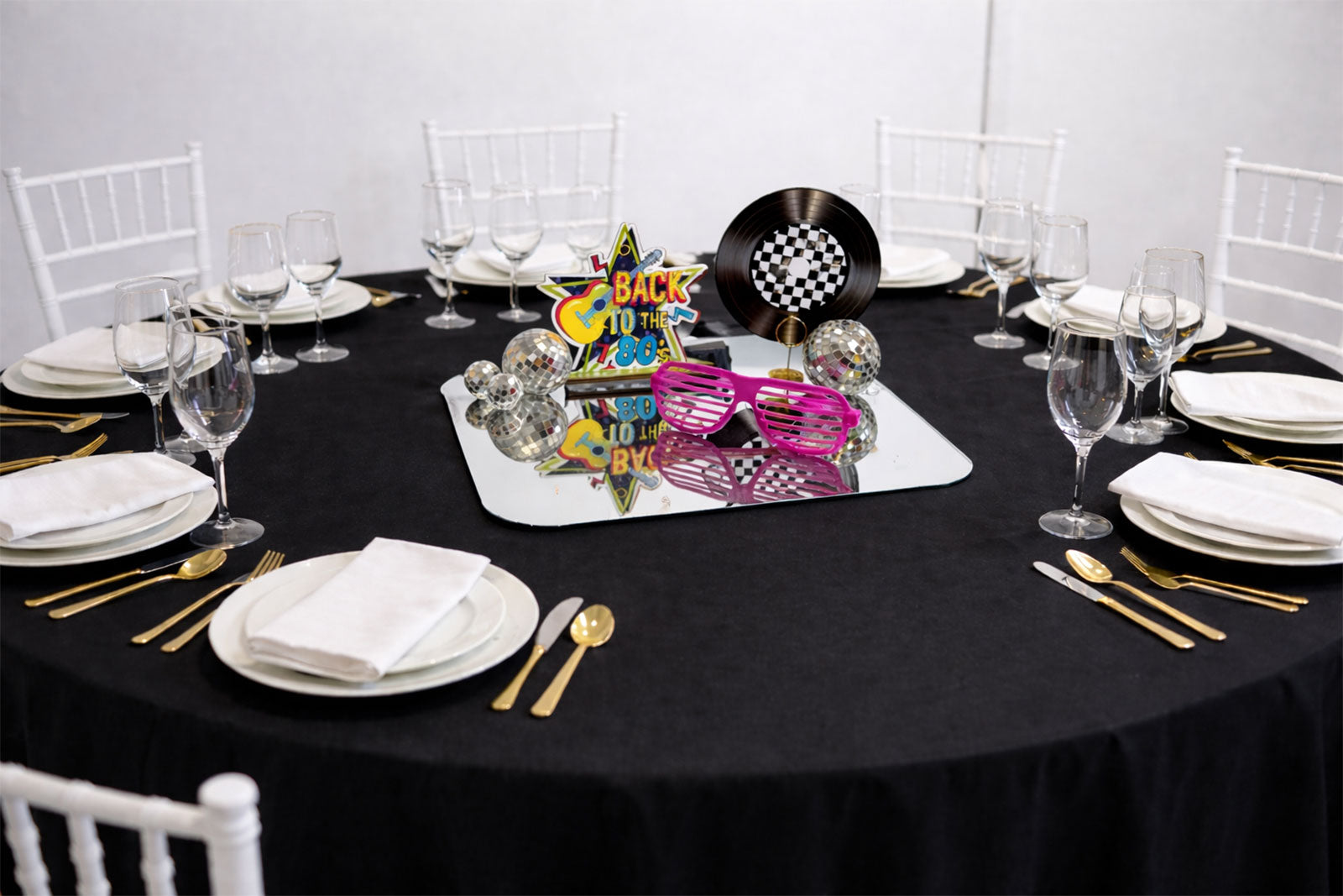 Vibrant 1980s-themed centrepiece featuring neon colors and retro decor, perfect for 80s party tables