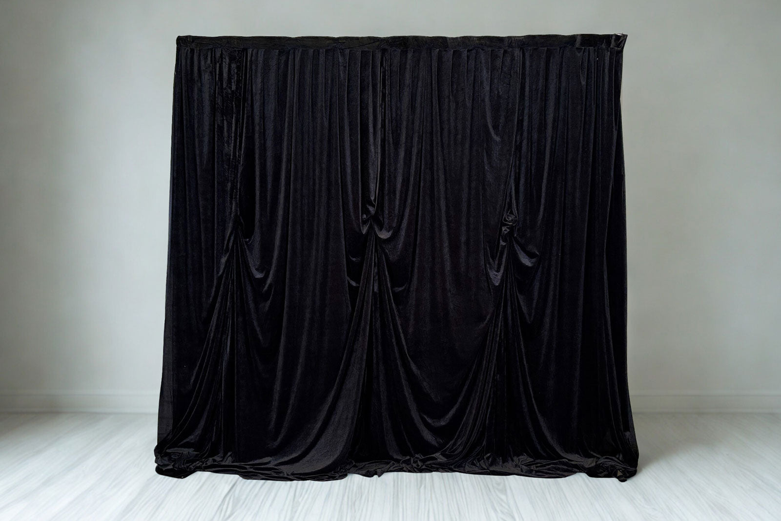 Black velvet draping backdrop with elegant flowing curtains, perfect for weddings, events, and photo walls.