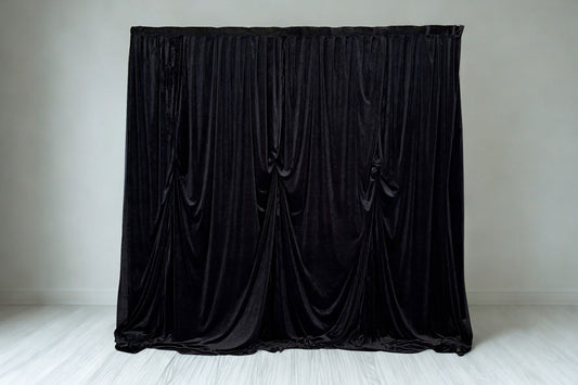 Black velvet draping backdrop with elegant flowing curtains, perfect for weddings, events, and photo walls.