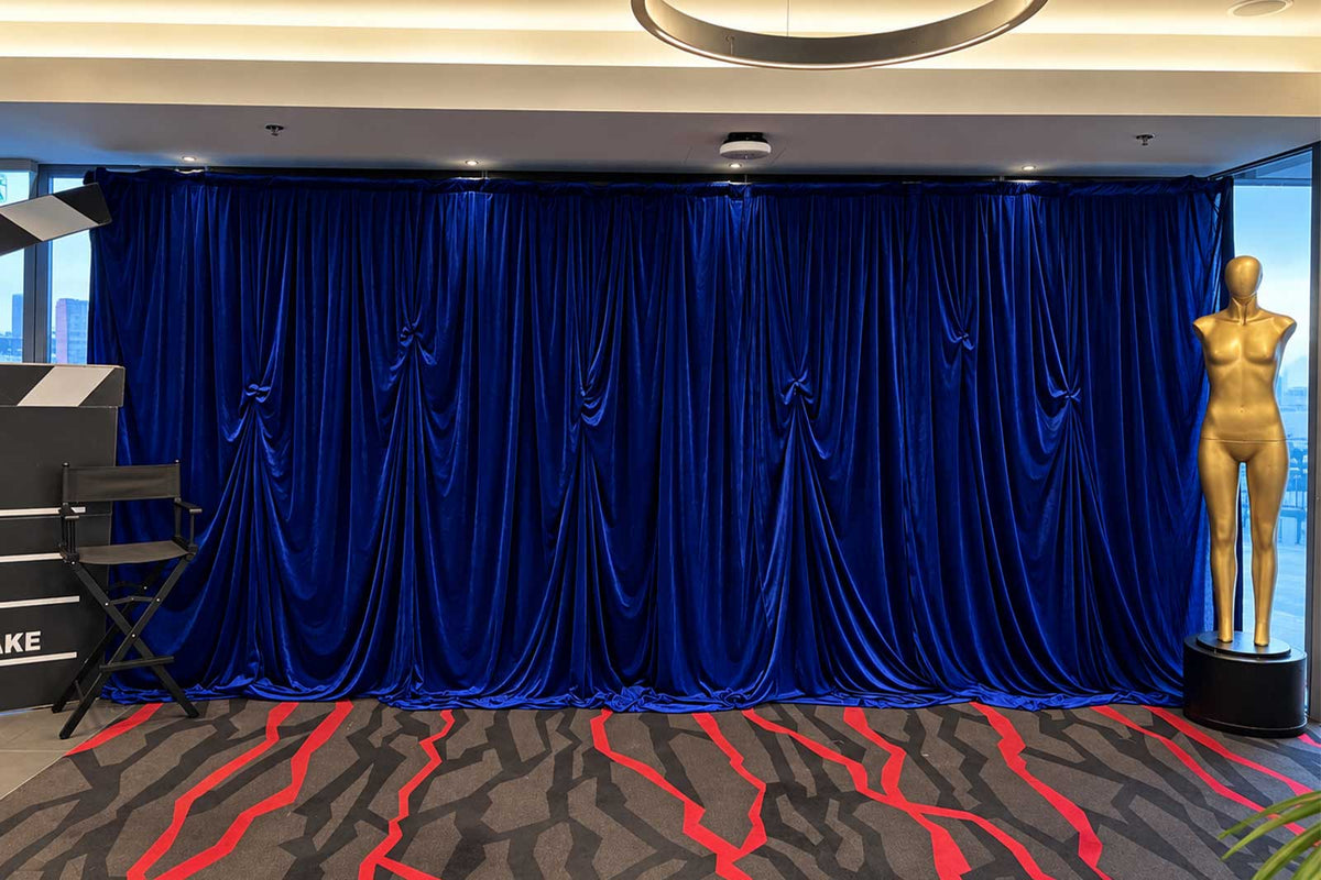 Blue draping for event backdrop and venue styling
