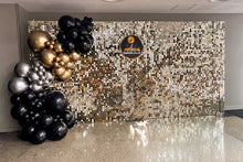 Load image into Gallery viewer, Decorative balloons in gold, black, and silver against a shimmer wall.
