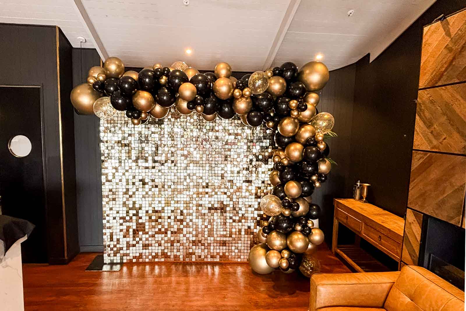 Shimmer wall and balloon garland creating a stylish backdrop for an Auckland corporate event