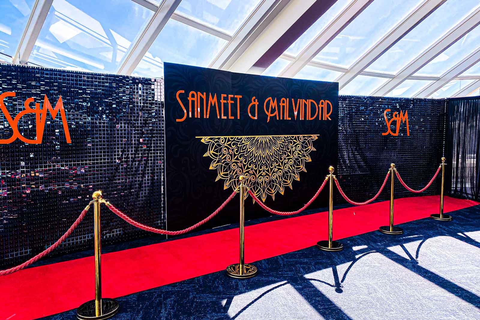Black shimmer wall backdrop with red carpet for elegant wedding celebrations and photo opportunities in Auckland