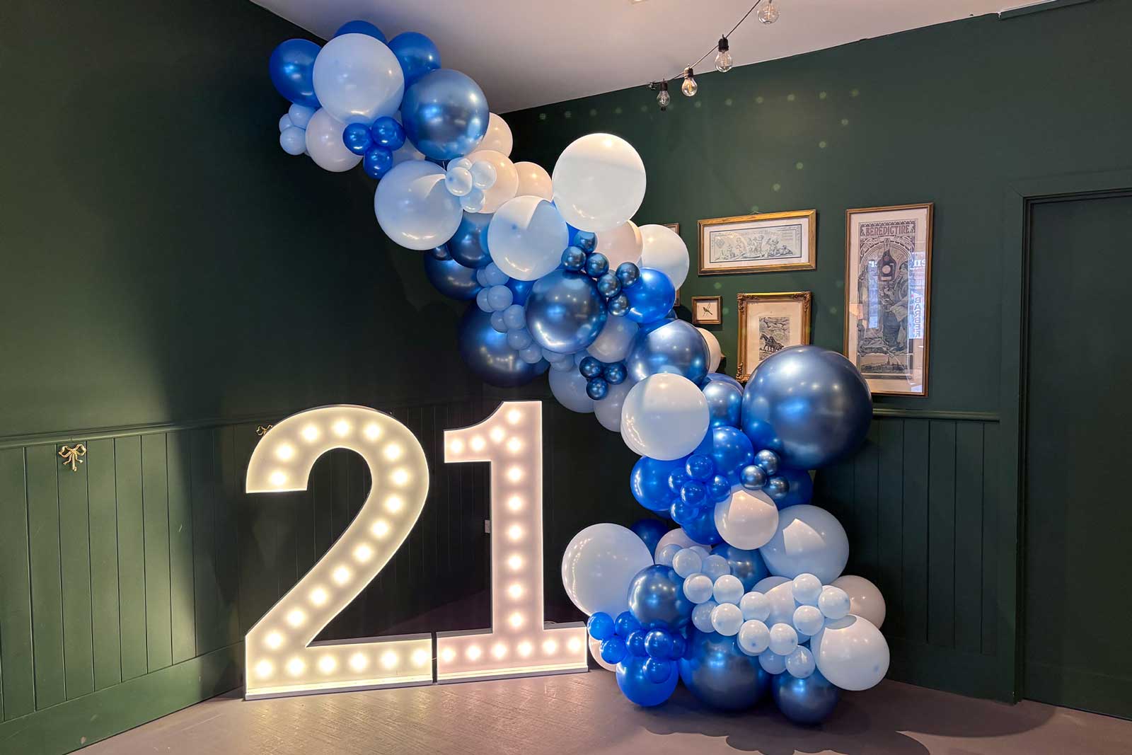 Balloon garland framing illuminated number display for celebration