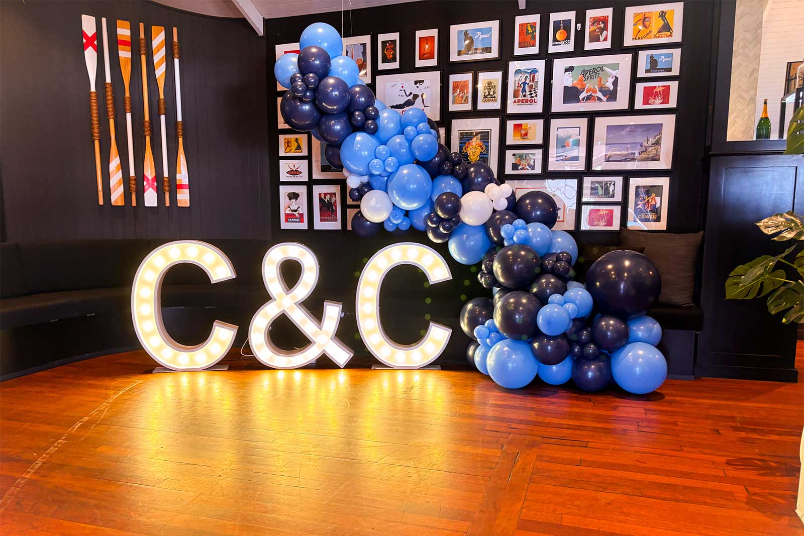 Balloon garland with light-up marquee letters at event backdrop