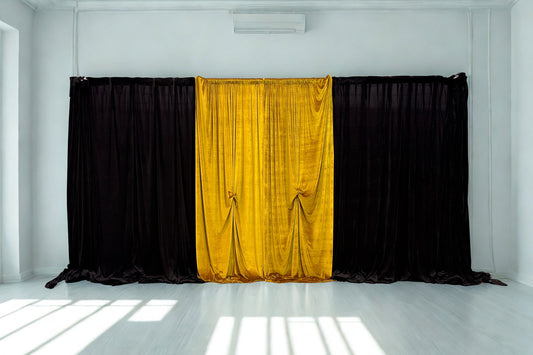 Black and gold curtain backdrop styled for a Great Gatsby or 1920s themed event, featuring bold Art Deco-inspired draping.