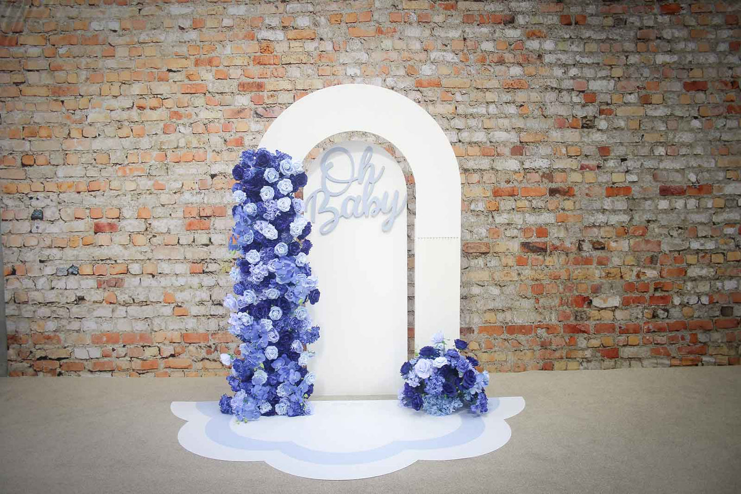 Elegant blue baby shower backdrop featuring "Oh Baby" signage, lush blue and white florals, organic balloon garland and luxury event styling in Auckland, NZ
