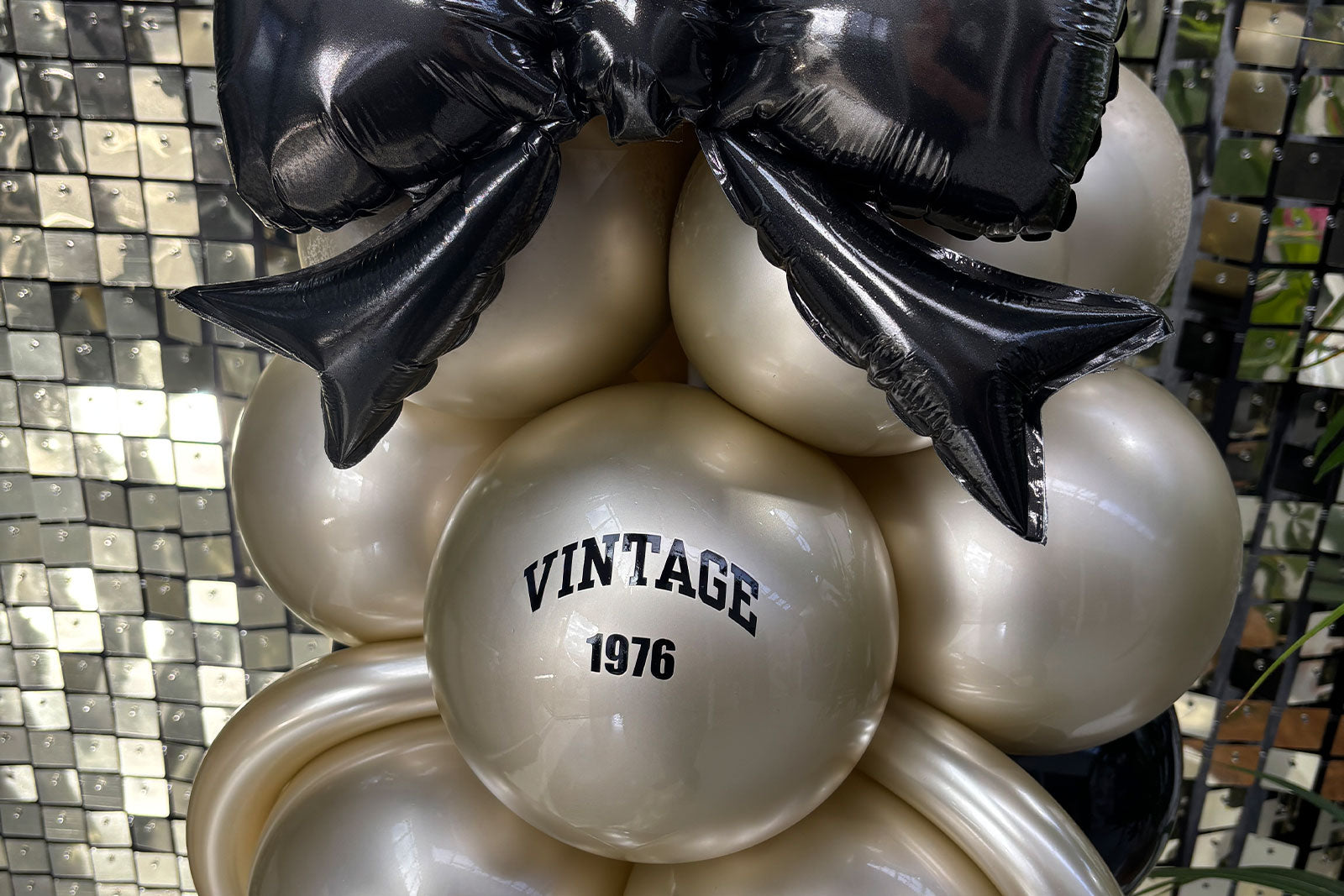 Champagne bottle themed balloon column creating a striking focal point for events and special celebrations.