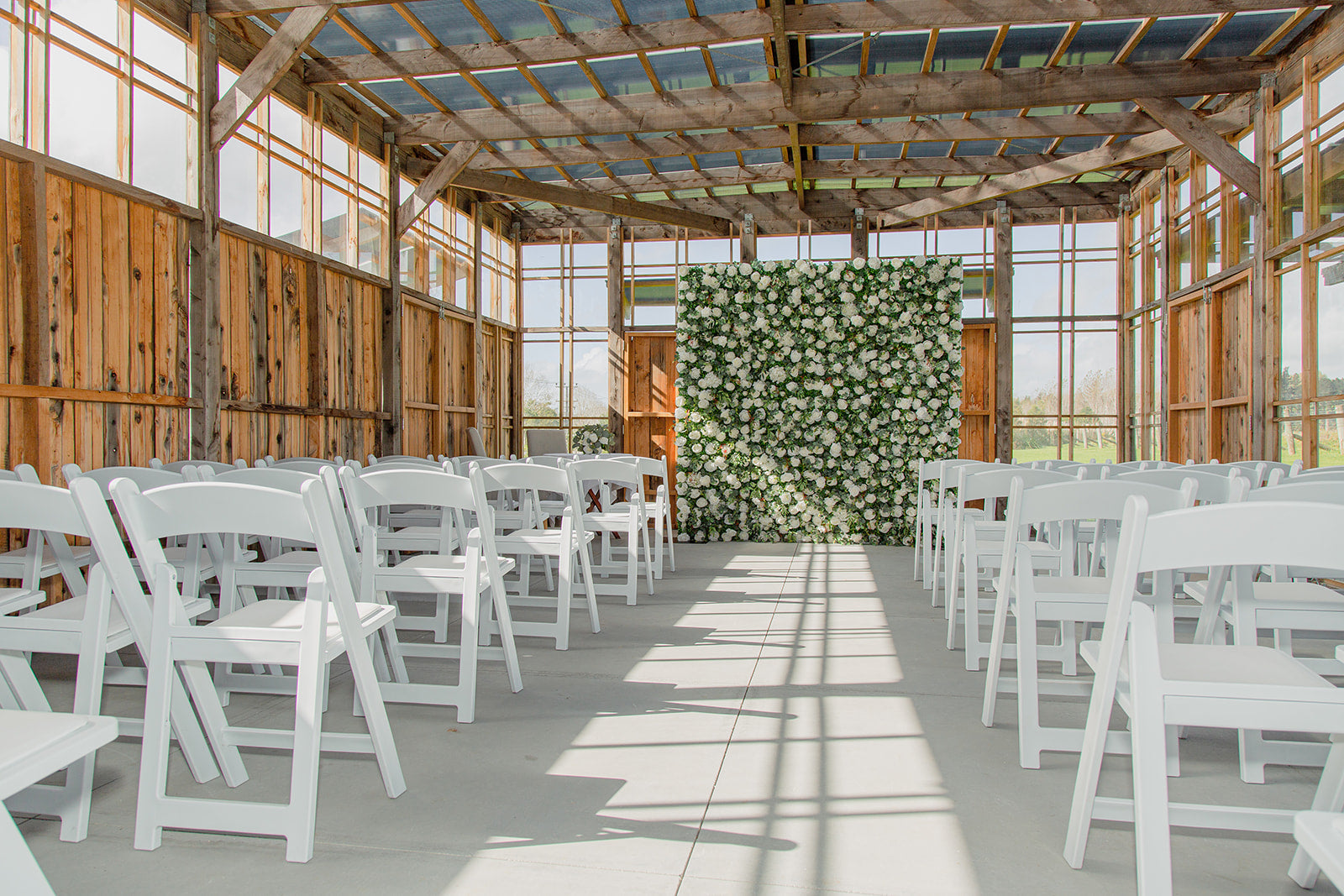 Classic white flower wall for elegant wedding ceremony and reception backdrops