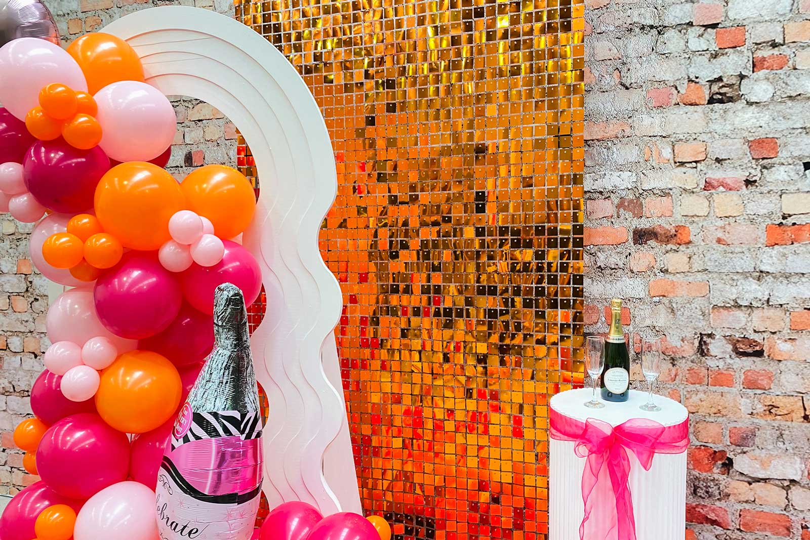 Copper shimmer wall backdrop creating a luxe look for weddings and evening celebrations