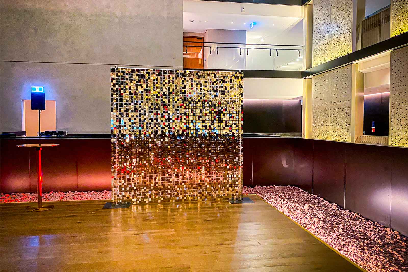 Professional corporate event setup featuring a plain white gold shimmer wall in Auckland