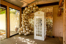 Load image into Gallery viewer, Auckland corporate celebration featuring a white phone booth and elegant shimmer wall.
