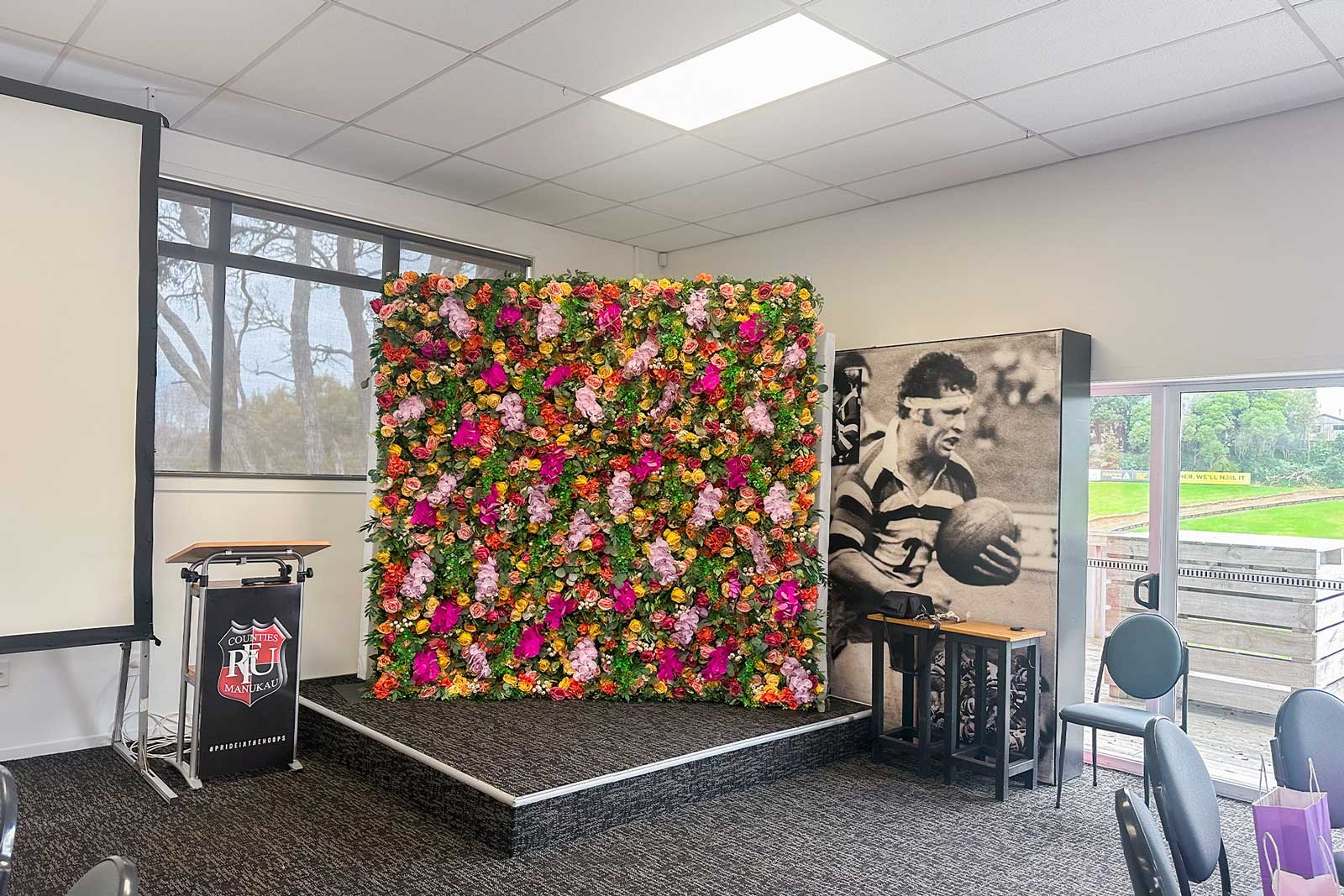 Event flower wall backdrop enhancing corporate branding and photo opportunities