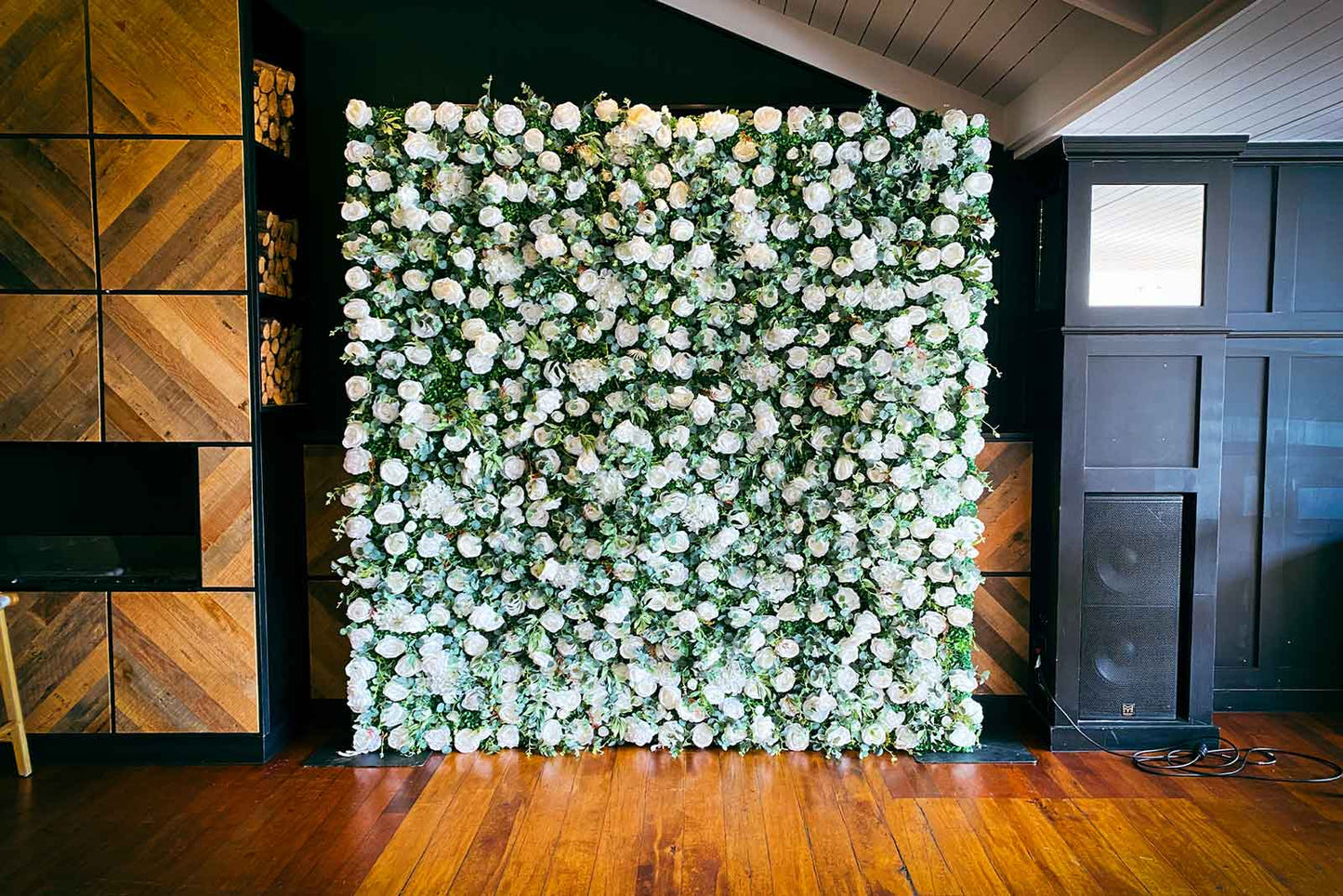 Floral wall backdrop for corporate events, ideal for networking and branded photo opportunities