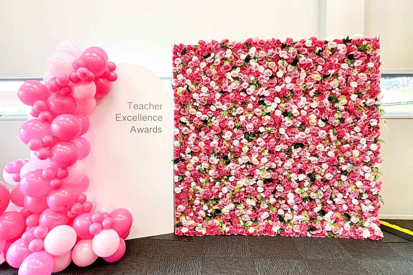 Arch backdrop stand with personalised print for brand activations and corporate events with flower wall and balloons