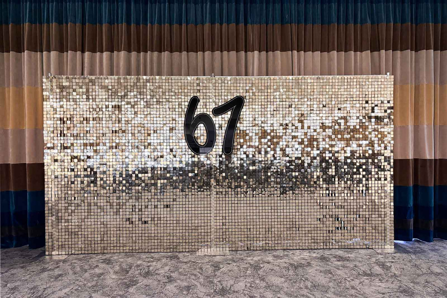 Custom event signage displayed on a white and gold shimmer wall at a corporate event in Auckland.