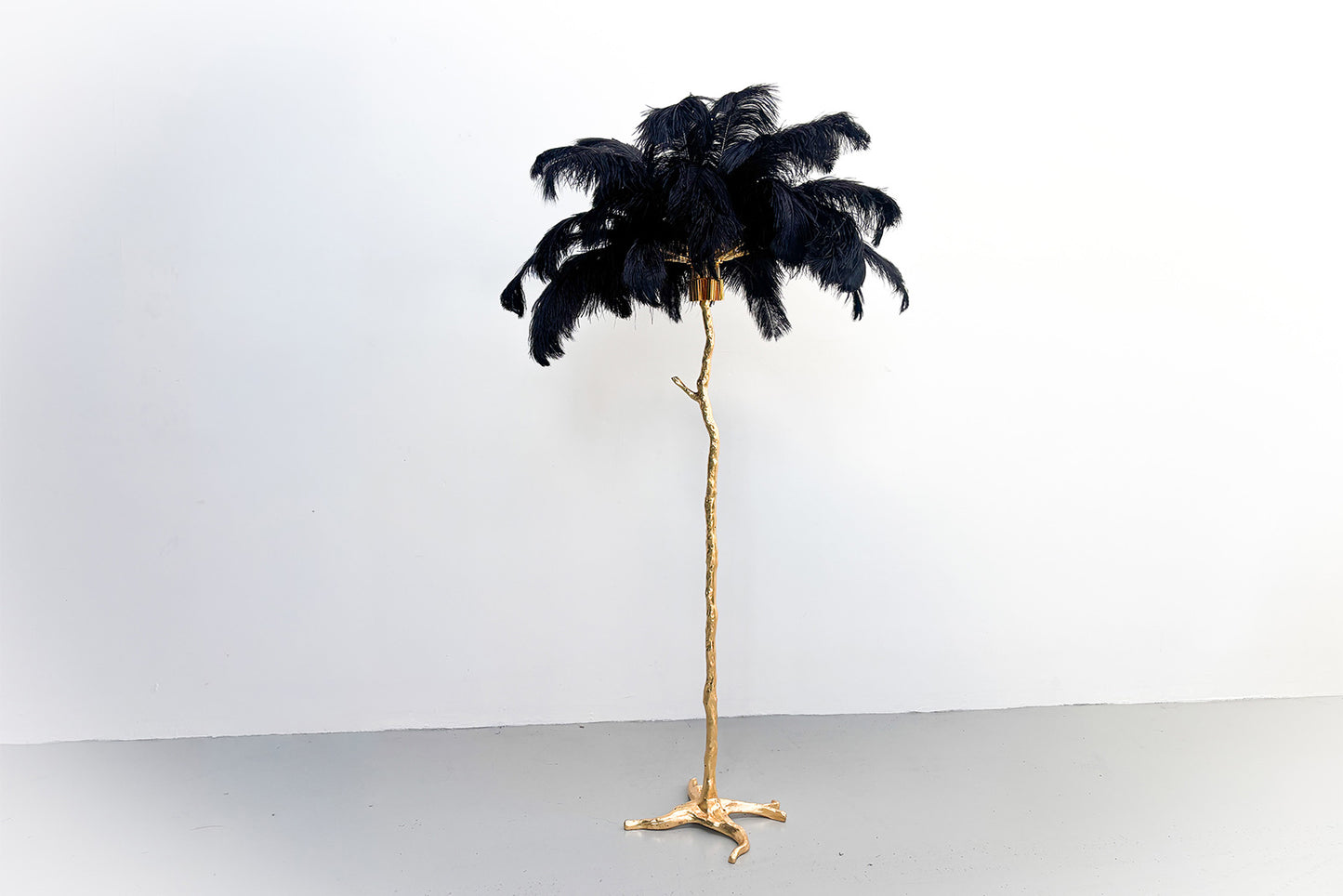 Elegant feather tree entrance display welcoming guests to weddings and corporate functions.