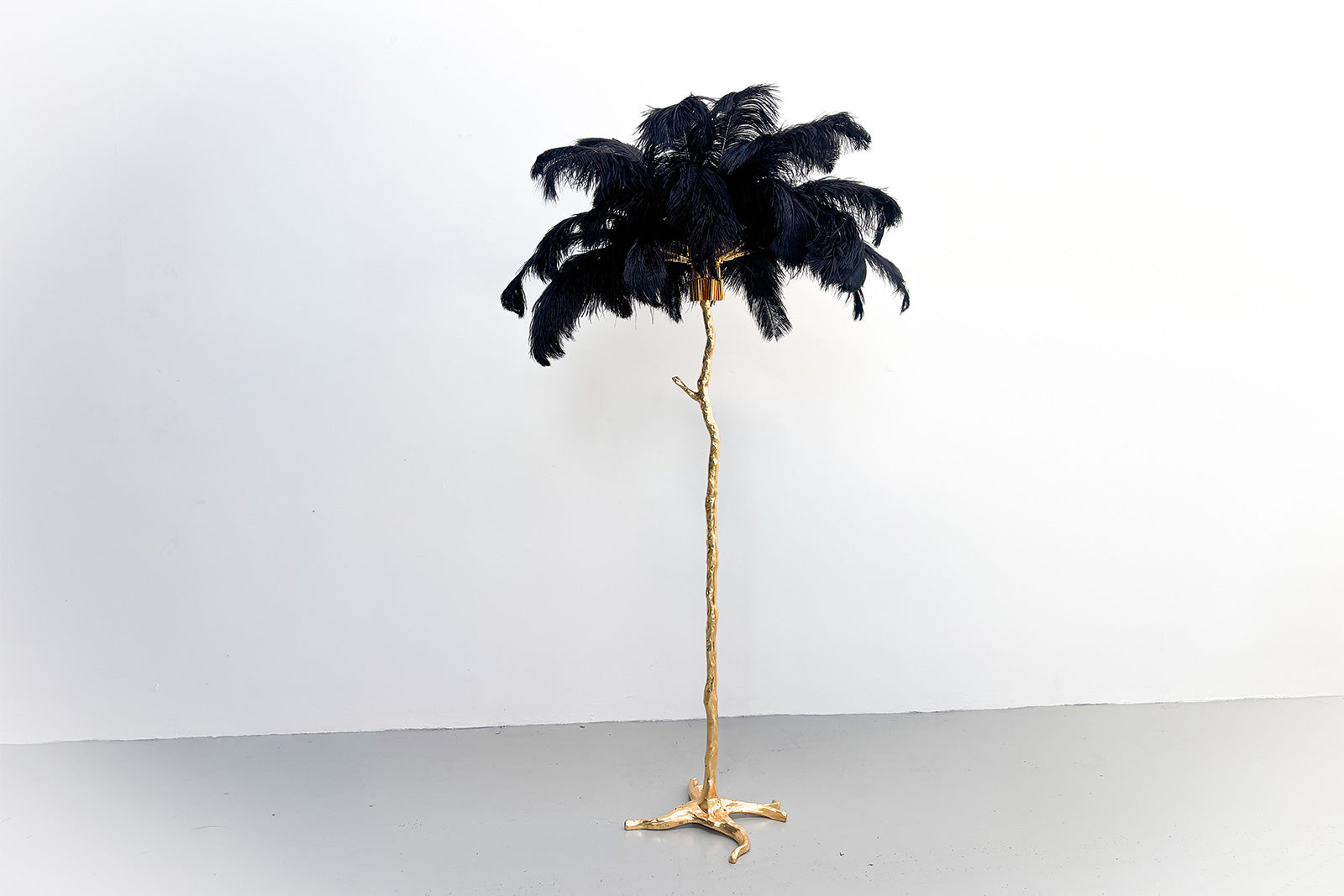 Elegant feather tree entrance display welcoming guests to weddings and corporate functions.