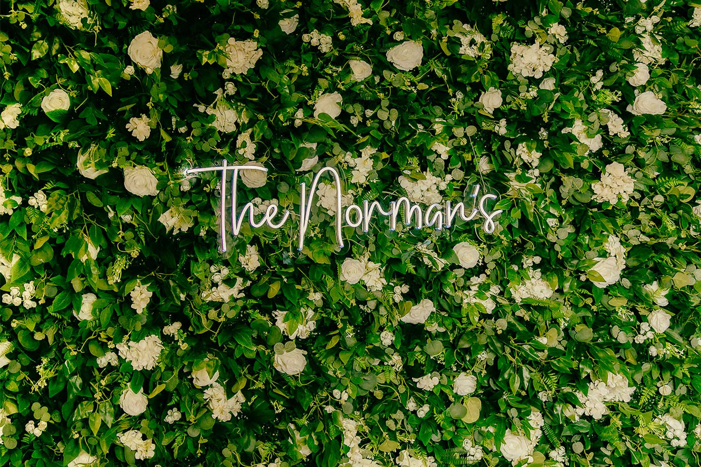 Flower wall backdrop with custom neon sign for weddings, bridal photos, and romantic celebrations in Auckland NZ