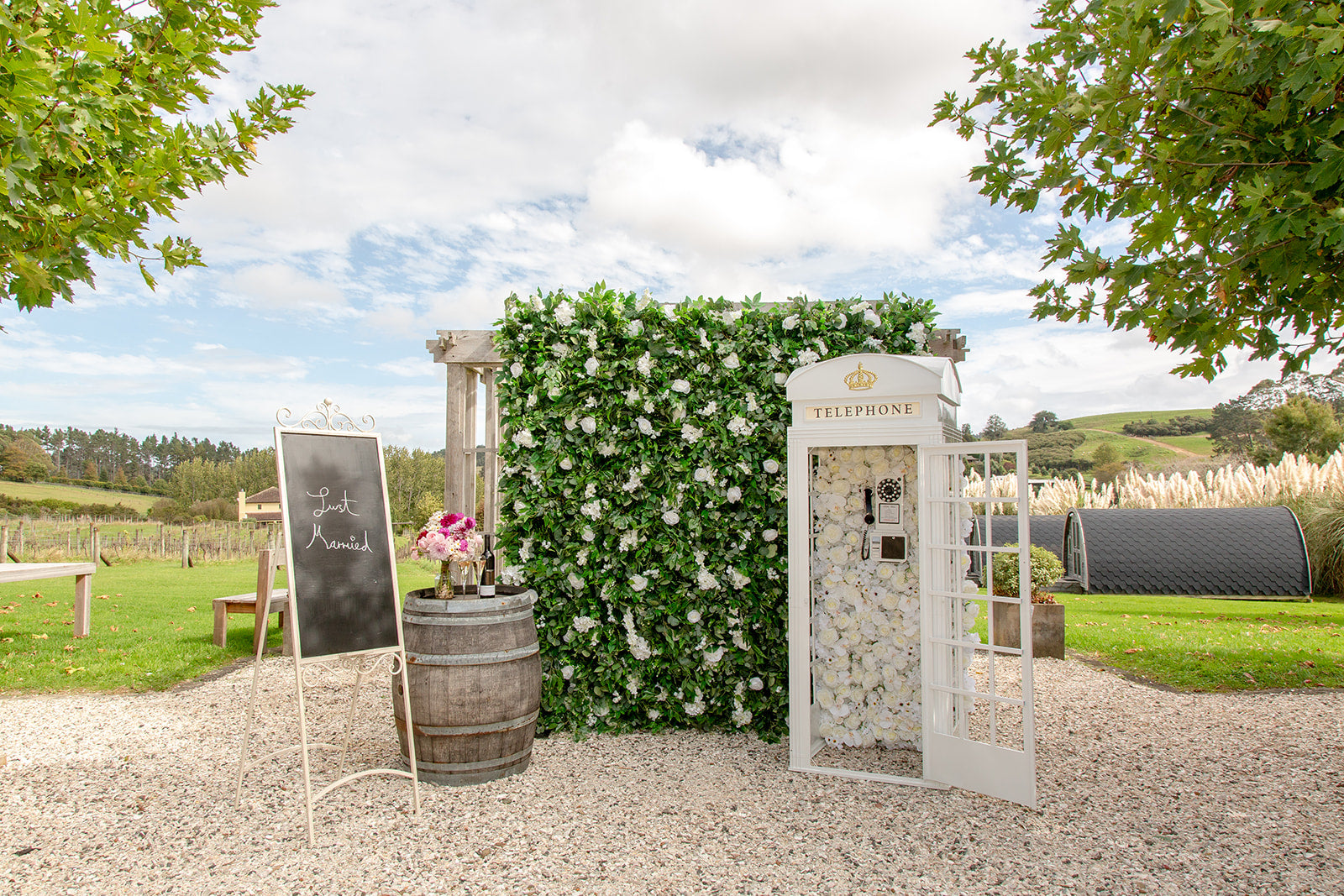 Flower wall backdrop with Phone Booth for wedding photo opportunities and bridal celebrations in Auckland NZ