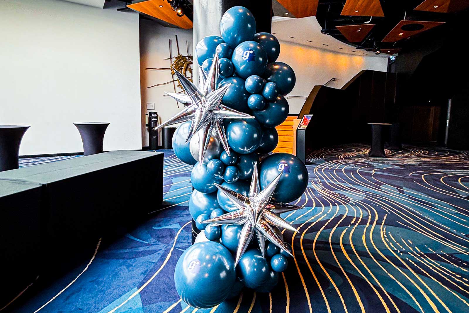 Freestanding balloon garland for corporate events styled in brand colours