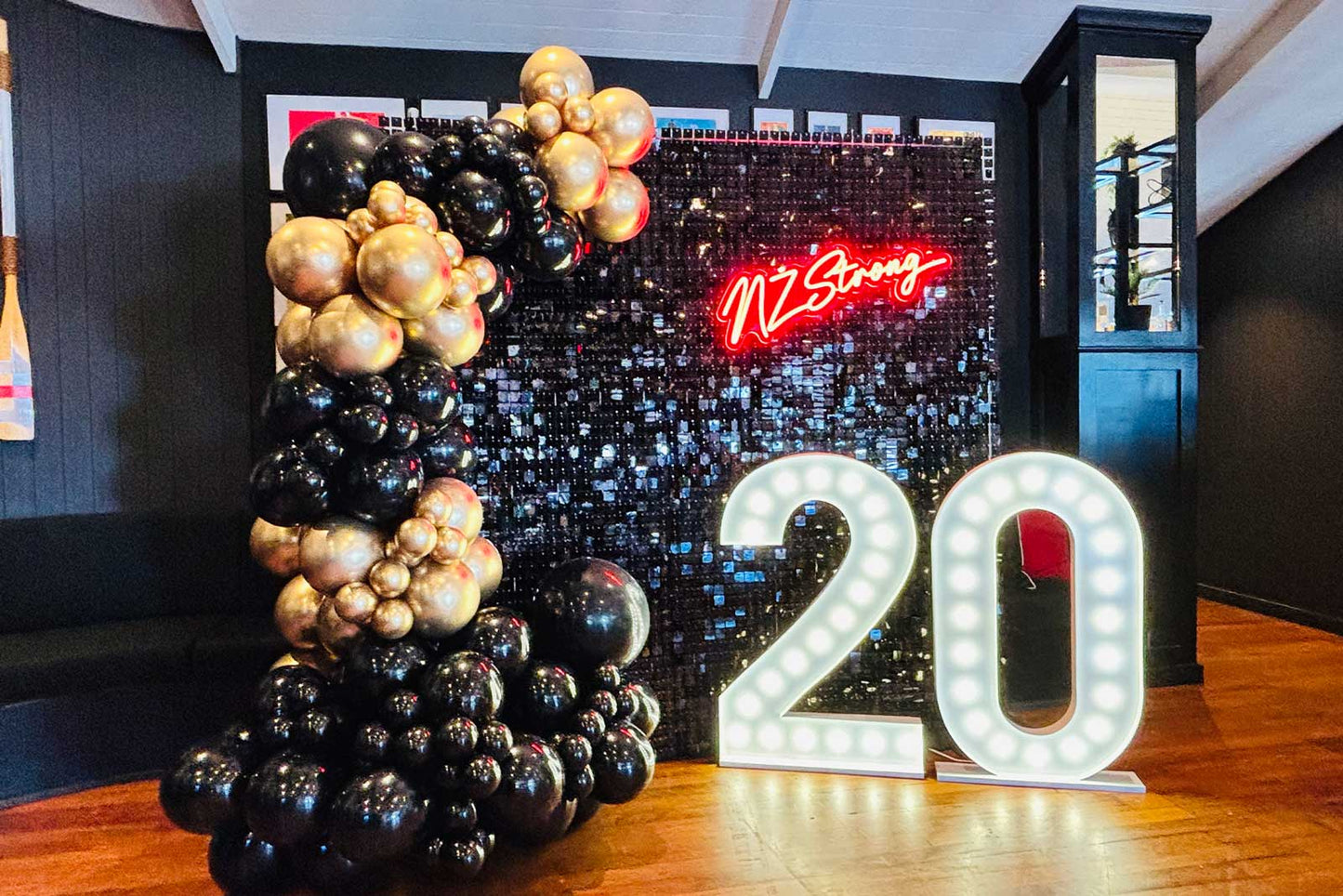 Gold and black shimmer wall party backdrop hire for stylish adult parties