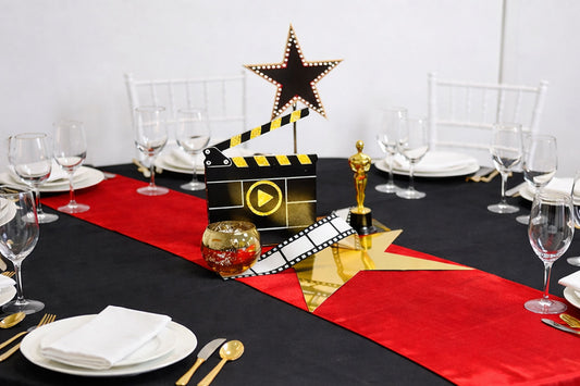 Glamorous Oscars-themed centrepiece with gold accents and cinematic details, perfect for award night tables