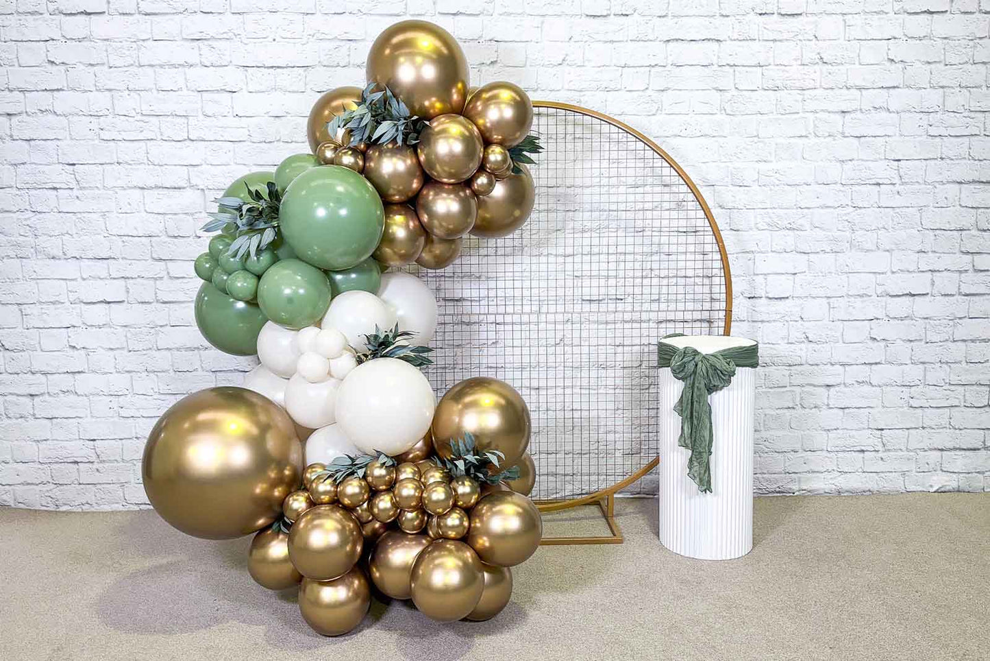 Gold mesh circle backdrop decorated with balloon garland for parties or events