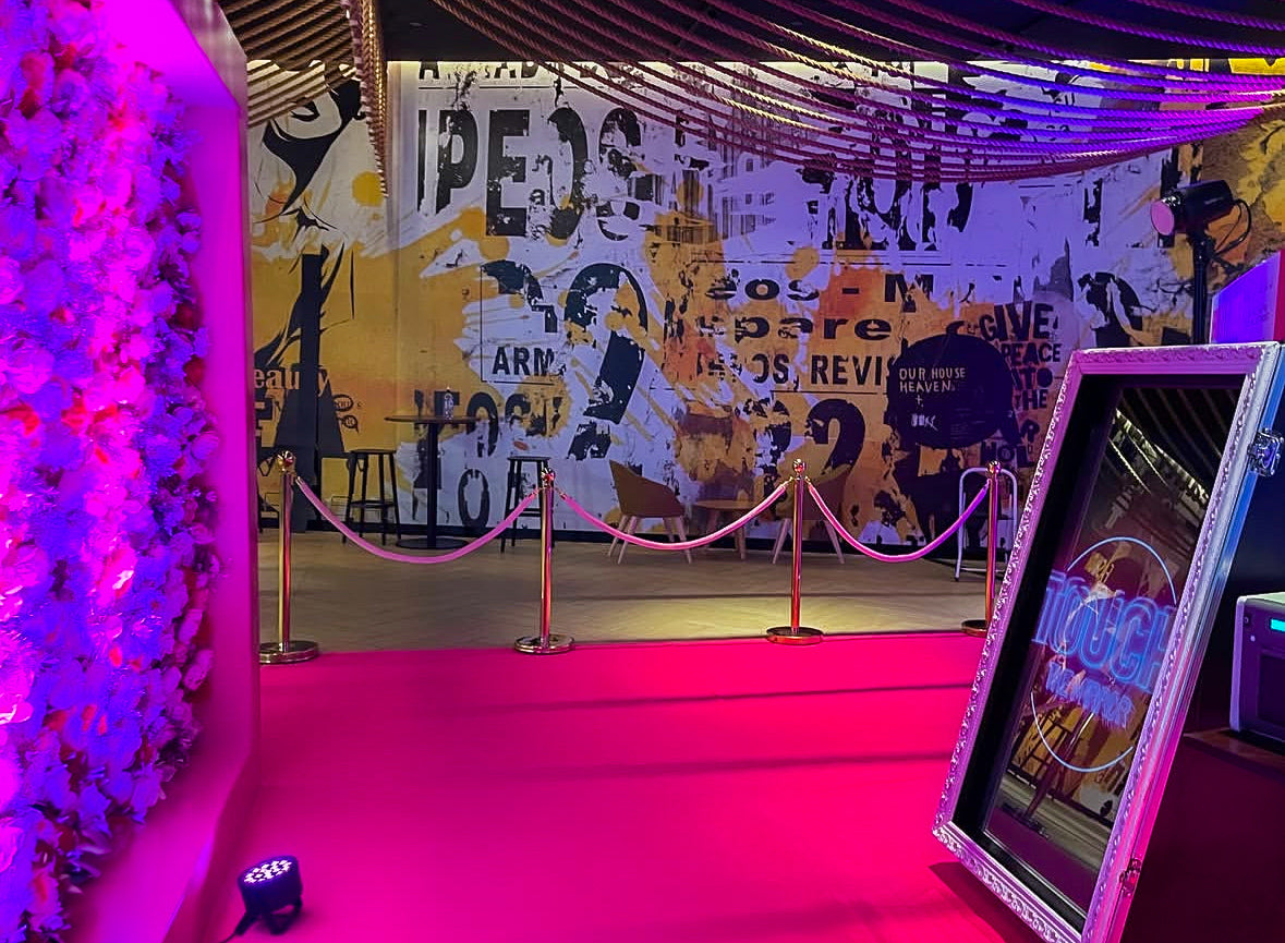 Elegant gold stanchions with pink rope to manage guest flow and style event spaces