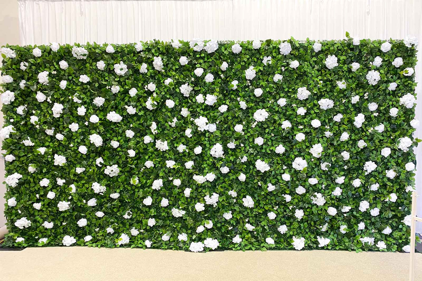 Elegant green and white floral wall for corporate conferences and networking